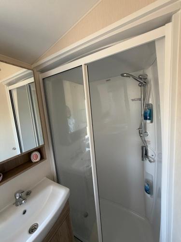 a bathroom with a shower and a sink at Teal - a few steps from the beach in Redcar