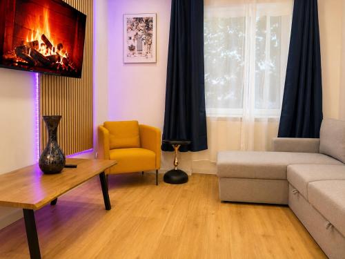 a living room with a couch and a chair at City Line Koblenz in Koblenz