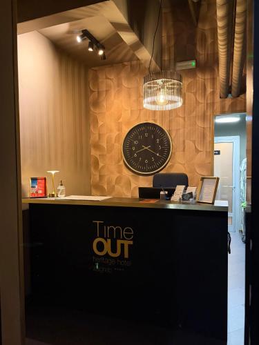 a counter with a clock on the wall at Timeout Heritage Hotel Zagreb in Zagreb