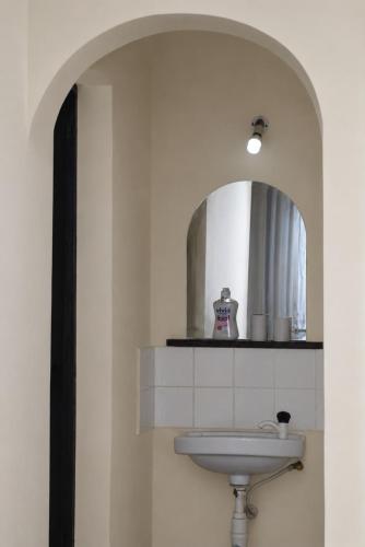 a bathroom with a sink and a mirror at Maya Comforts in Ukunda