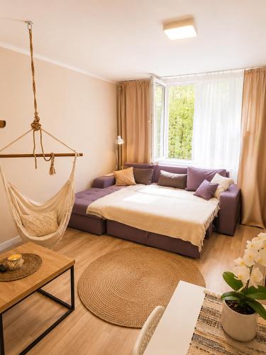 a bedroom with a bed and a hammock at Boho Quiet Studio Kraków in Krakow