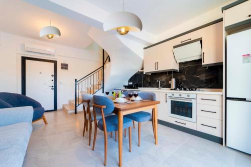 a kitchen and dining room with a table and chairs at Villa Kaş B in Kaş