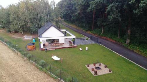 an aerial view of a small house in a yard at Domek Las&Luz Moszna BALIA in Moszna