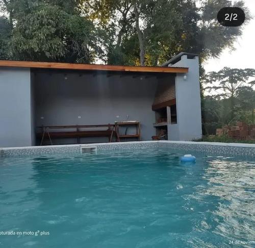 a swimming pool in front of a house at Quinta Bommerl in Paso de la Patria