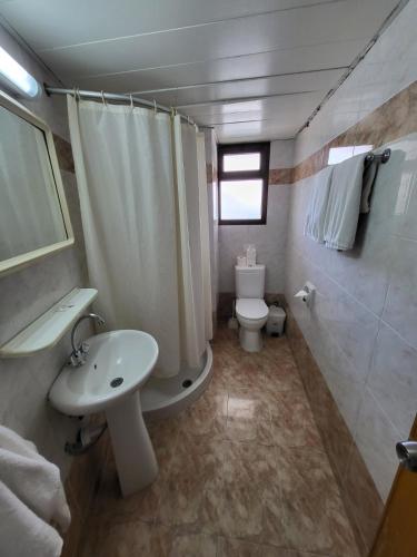 a bathroom with a sink and a toilet and a shower at Corallia Beach Hotel Apartments in Coral Bay