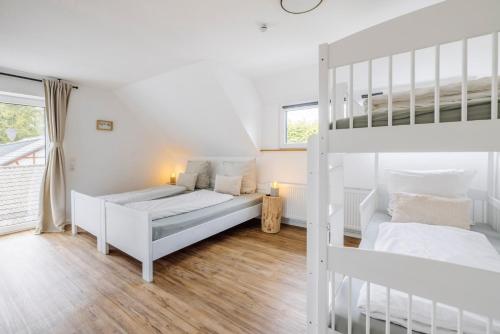 a bedroom with two beds and a bunk bed at Traumfabrik Eifel mit Sauna & Whirlpool in Monschau