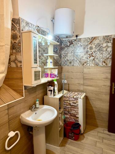 a bathroom with a sink and a mirror and a sink at Casale di Torvaianica in Campo Iemini