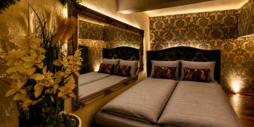a bedroom with two beds in a room with flowers at Sofia Private Wellness Apartman Prague - Sauna & Jacuzzi in Prague