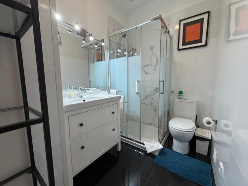 a bathroom with a shower and a toilet and a sink at Lisbon Downtown Inn in Lisbon