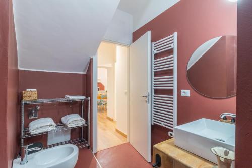 a bathroom with a white sink and a mirror at PianoPiano Nel cuore del borgo di Viterbo P1 in Viterbo