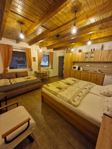 a large bedroom with two beds and a table at Apartmány pod pergolou in Bořetice