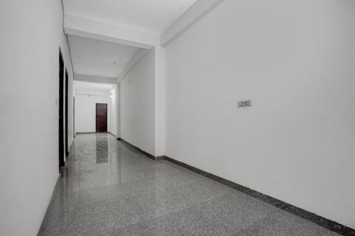 an empty hallway with white walls and concrete floors at SPOT ON VS in Delhi
