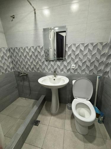 a bathroom with a toilet and a sink at Relax garden area with BBQ zone in Yerevan
