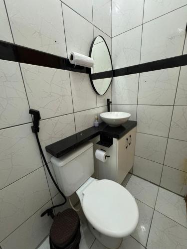 a bathroom with a white toilet and a sink at AP 06 - Apartamento Estudio completo in Balsas