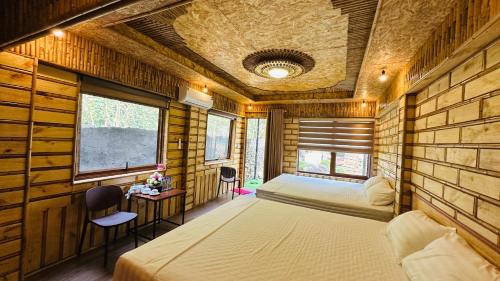 a bedroom with a bed in a room with wooden walls at Mây Retreat in Nguyên Ngoại