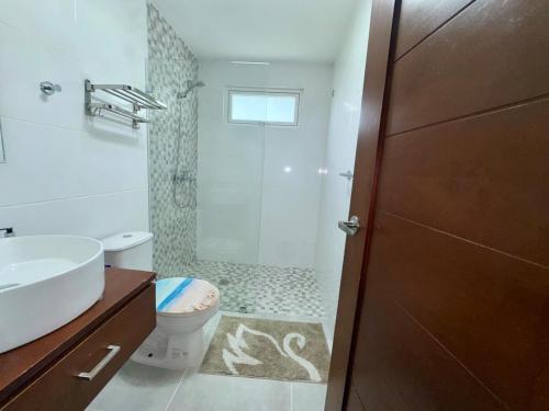 a bathroom with a sink and a toilet and a shower at Tepuy Residential in Juan Dolio