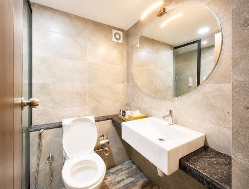 a bathroom with a sink and a toilet and a mirror at NEAR SHREE RAM JANM BHOOMI - HOTEL SHREE RR - Wi-Fi - Parking- Luxury Rooms - Best Family Hotel In Ayodhya in Ayodhya