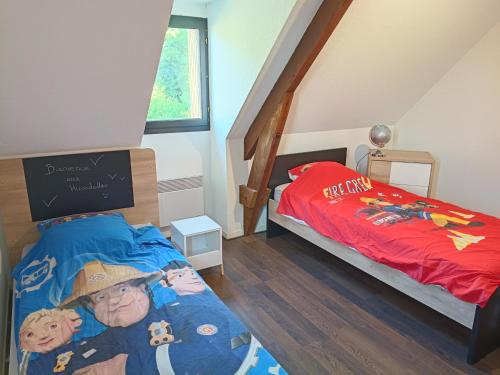 a childs bedroom with a bed with a cartoon on it at Charmante maison avec jacuzzi privatif in Saint-Salvadour