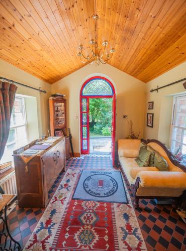a living room with a couch and a window at Knockaderry House in Ennis
