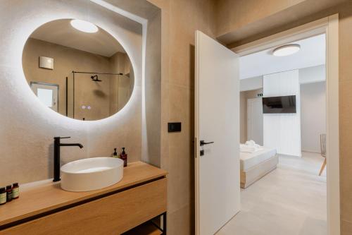 a bathroom with a sink and a mirror at Anema Living in Parga