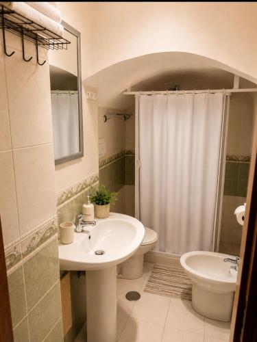 a bathroom with a sink and a toilet and a shower at Apartment in Salerno Centro in Salerno