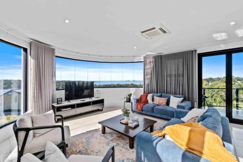 a living room with a blue couch and a tv at Seabreeze Sanctuary in Long Beach