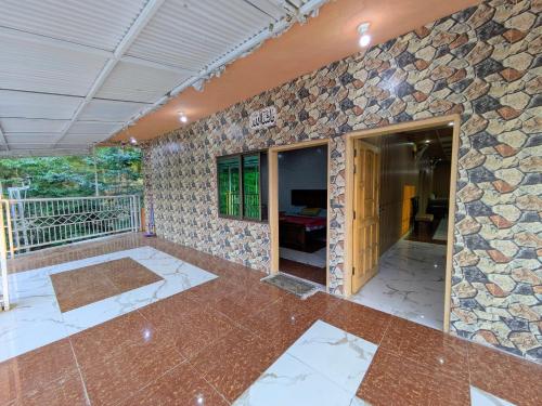 an empty room with a stone wall at Afridi Apartment in Murree