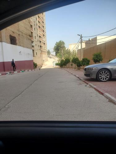 a car parked on the side of a street at Appartement a bir mourad rais in Birmandreis