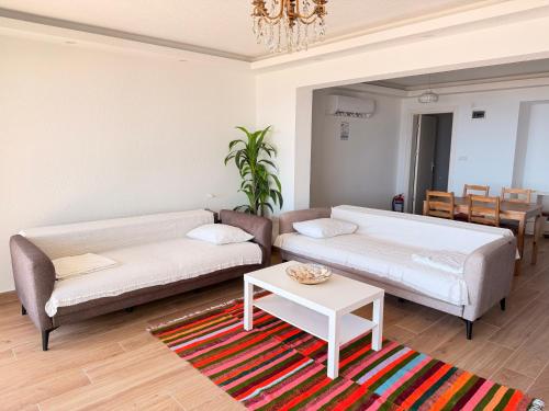 a living room with a couch and a table at BODRUM BURCU RESIDENCE, Magnificent Sea View, Cozy, Free Otopark, Free Wifi in Bodrum City