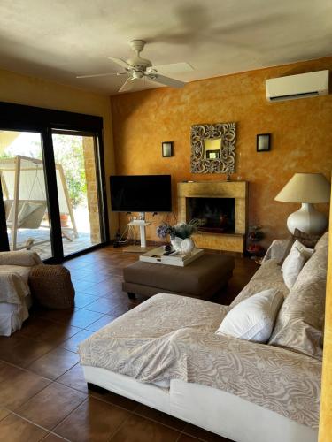 a living room with a bed and a fireplace at Country Vila in Nikiti