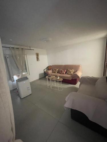 a living room with a couch and a table at T2 avec terrasse privative Berre-l'Étang in Berre-lʼÉtang