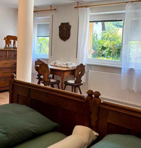 a bedroom with a table and chairs and a window at Vorderschöneck 2 in Longostagno