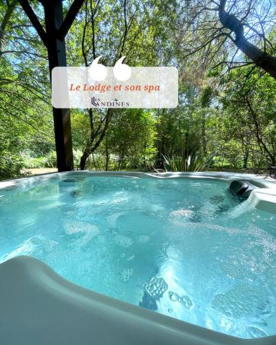 a hot tub with a sign that reads ice house at son spa at Cabanes et Spa Les Landines in Origne