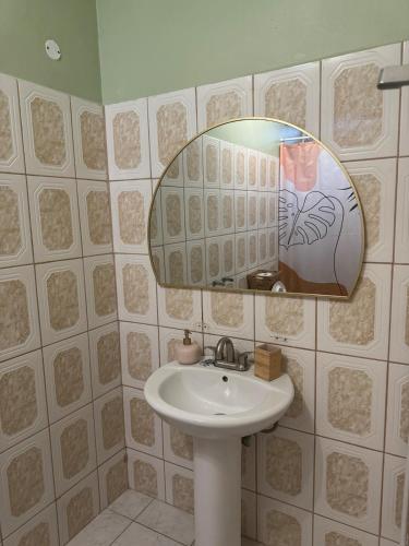 a bathroom with a sink and a mirror at Papaya Condo in Portsmouth