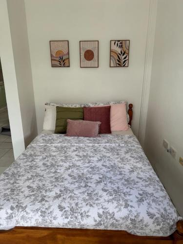 a bedroom with a large bed with pillows on it at Papaya Condo in Portsmouth