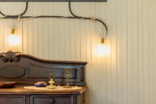a room with a table with two lights on the wall at Dimora Pellegrino in Torre Pellice
