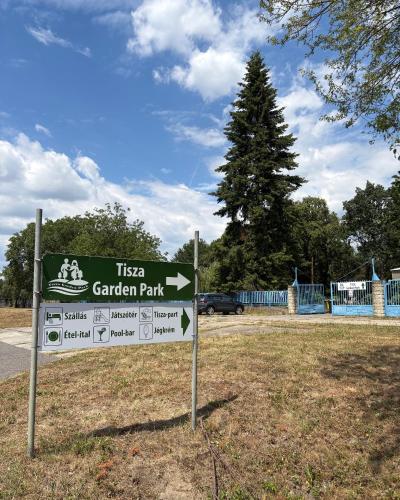 a sign for the tica garden park in a park at Tisza Garden Park in Tiszalök