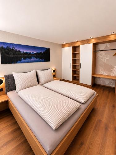 a bedroom with a large bed in a room at NEU ab Juli 2026 - Apart Kneringer in Prutz