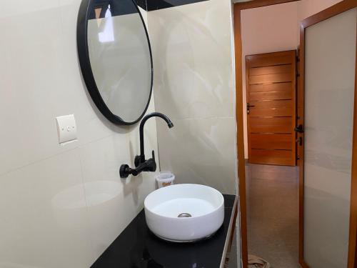 a bathroom with a white toilet and a mirror at Chamber double in Saly Portudal