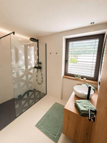 a bathroom with a shower and a toilet and a sink at NEU ab Juli 2026 - Apart Kneringer in Prutz