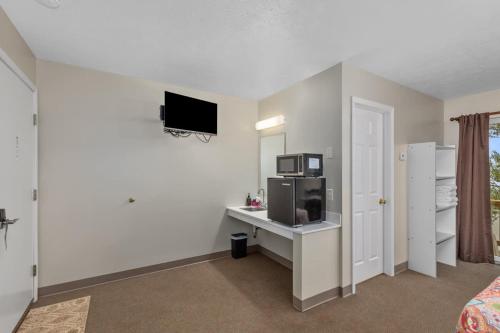 a room with a desk with a microwave and a tv at Upper Level Lakeview suite in Lake City