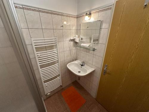 a bathroom with a sink and a mirror at Max and Moritz Top 7 in Liebenau