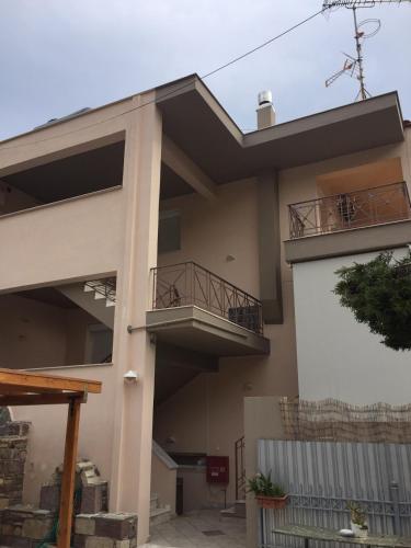 a house with two balconies on the side of it at Hotel Pelagos Studios in Platána