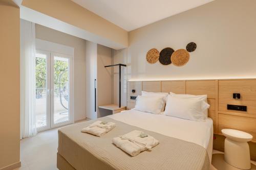 a bedroom with a bed with towels on it at Anema Living in Parga