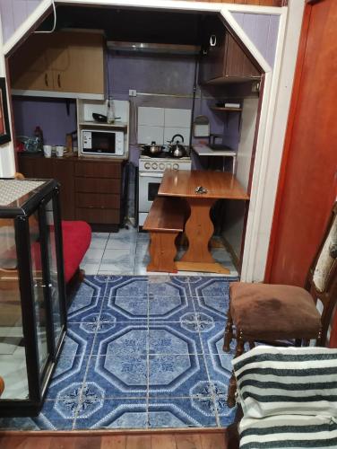 a small kitchen with a table and a stove at Hospedaje Alondra in Osorno