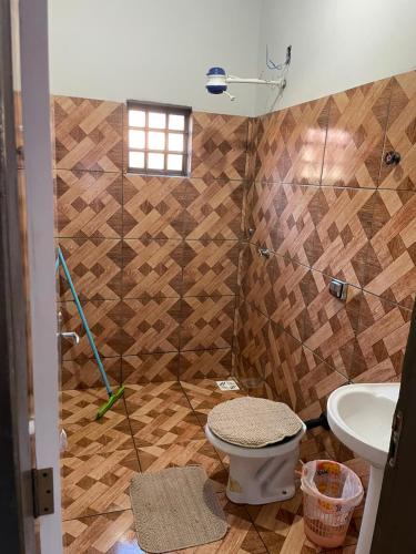 a bathroom with a toilet and a sink at Casa tranquila próximo ao centro e a Unigran in Dourados