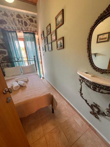 a bathroom with a sink and a mirror at Kyma in Gerolimenas