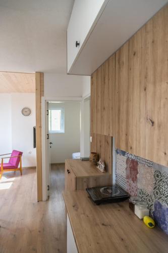 a kitchen with wooden walls and a counter top at na obali drine in Perućac