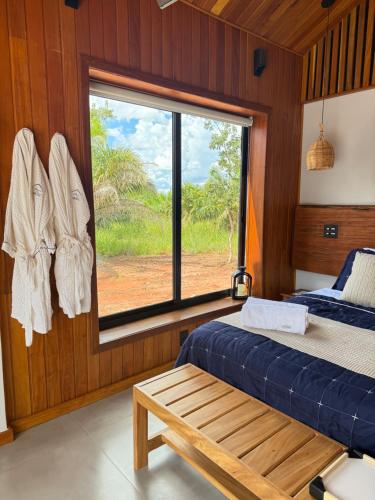 a bedroom with a bed and a window with a view at Cabana Komodo Bonito in Bonito