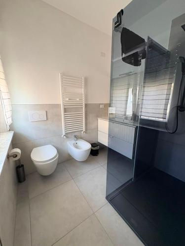 a bathroom with a toilet and a sink at Corte del Gallo in Legnano